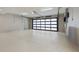 Spacious and well-lit garage featuring a modern glass panel garage door at 590 De Narvaez Dr, Longboat Key, FL 34228