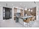 Modern kitchen with a large center island, bar seating, and contemporary lighting fixtures at 590 De Narvaez Dr, Longboat Key, FL 34228