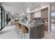 Expansive open kitchen with a large center island, breakfast bar, seamless access to the living, and dining areas at 590 De Narvaez Dr, Longboat Key, FL 34228