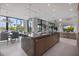 Open kitchen design featuring a large island, dining area, and inviting living space for seamless entertaining and Gathering time at 590 De Narvaez Dr, Longboat Key, FL 34228
