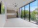 Large room with big windows, a ceiling fan, and views of the exterior environment at 590 De Narvaez Dr, Longboat Key, FL 34228