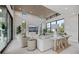 Living room with stylish decor, a modern fireplace, and large windows offering scenic views at 590 De Narvaez Dr, Longboat Key, FL 34228