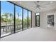 Spacious living room with large windows, a ceiling fan, and views of the scenic waterfront at 590 De Narvaez Dr, Longboat Key, FL 34228