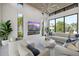 Elegant living room featuring a modern fireplace, stylish furniture, and large windows at 590 De Narvaez Dr, Longboat Key, FL 34228