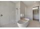 This bathroom features a walk-in shower, modern soaking tub, and easy access to the closet at 590 De Narvaez Dr, Longboat Key, FL 34228