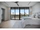 This is the main bedroom with a king bed and a wall of glass that looks out to an expansive view at 590 De Narvaez Dr, Longboat Key, FL 34228
