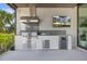 Outdoor kitchen features a built-in grill, refrigerator, and counter space for entertaining at 590 De Narvaez Dr, Longboat Key, FL 34228