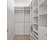 Well-organized walk-in closet featuring custom shelving and hanging rods, maximizing space at 590 De Narvaez Dr, Longboat Key, FL 34228