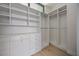 Bright walk-in closet with custom shelving, drawers, and ample storage space, perfect for organization at 590 De Narvaez Dr, Longboat Key, FL 34228