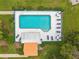 Aerial shot of a pristine community pool area with lounge chairs and picnic tables at 6755 Approach Rd # 31, Sarasota, FL 34238