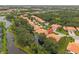 Waterfront community with terra cotta tile roofs, lush landscaping, and mature trees located near lakes and canals at 6755 Approach Rd # 31, Sarasota, FL 34238