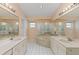 Large bathroom with double vanities, tiled floors, soaking tub, and glass shower at 6755 Approach Rd # 31, Sarasota, FL 34238