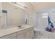 Bright bathroom featuring a tub, vanity, sink, and large mirror at 6755 Approach Rd # 31, Sarasota, FL 34238
