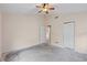 Neutral bedroom featuring ceiling fan, closet, and view to a hallway at 6755 Approach Rd # 31, Sarasota, FL 34238