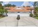 Exterior view of two-story home featuring a driveway and matching two-car garages at 6755 Approach Rd # 31, Sarasota, FL 34238