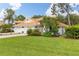Beautiful white home with vibrant landscaping and a tile roof, offering great curb appeal at 6755 Approach Rd # 31, Sarasota, FL 34238
