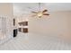 Spacious living room features tile flooring, ceiling fan, and leads into the kitchen at 6755 Approach Rd # 31, Sarasota, FL 34238