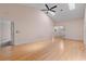 Bright living area featuring wood flooring, vaulted ceiling, skylight, and ceiling fan at 6755 Approach Rd # 31, Sarasota, FL 34238