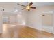 Open living room boasting natural light, skylight, wood floors, and access to the entry and kitchen at 6755 Approach Rd # 31, Sarasota, FL 34238