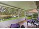 Relaxing covered patio with comfortable seating and serene water views at 6755 Approach Rd # 31, Sarasota, FL 34238