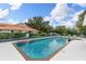 Community pool with clear water, pool furniture, and lush landscaping at 6755 Approach Rd # 31, Sarasota, FL 34238
