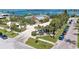 Elevated view of a charming neighborhood with waterfront access, showcasing tropical landscaping and convenient parking at 681 Fox St, Longboat Key, FL 34228