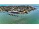 Scenic aerial view of waterfront property with boat docks and a restaurant, perfect for boating enthusiasts at 681 Fox St, Longboat Key, FL 34228