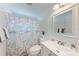 Charming bathroom with ocean-themed shower curtain and vanity at 681 Fox St, Longboat Key, FL 34228