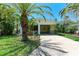 Charming single-story home with a carport, lush landscaping, and mature palm trees at 681 Fox St, Longboat Key, FL 34228