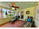 Relaxing lanai with lounge chairs, unique ceiling fan, and view to the outdoors at 681 Fox St, Longboat Key, FL 34228