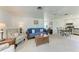 Spacious living room showcasing neutral walls, ceiling fan, and seamless flow to the kitchen at 681 Fox St, Longboat Key, FL 34228