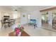 Open living space with tile floors, easy access to the kitchen and screened porch at 681 Fox St, Longboat Key, FL 34228
