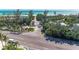 A beach view over a parking lot, road, and trees at 681 Fox St, Longboat Key, FL 34228