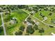 Scenic aerial view showcasing the property's house, barn, pool, and verdant landscape at 6875 Myakka Valley Trl, Sarasota, FL 34241