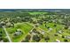 Expansive aerial view featuring numerous houses, barns, and the property's lush greenery at 6875 Myakka Valley Trl, Sarasota, FL 34241