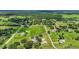 Vast aerial view featuring houses, barns, and lush greenery amidst a community at 6875 Myakka Valley Trl, Sarasota, FL 34241