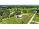 Expansive property featuring a well-maintained home, outbuildings, and lush greenery at 6875 Myakka Valley Trl, Sarasota, FL 34241