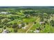 A large parcel of land is ready for development surrounded by lush greenery, homes, and a serene pond at 6875 Myakka Valley Trl, Sarasota, FL 34241
