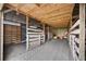 Barn interior featuring wooden stalls and dirt floor, perfect for housing livestock or storing equipment at 6875 Myakka Valley Trl, Sarasota, FL 34241