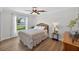 Cozy bedroom with window and laminate wood flooring at 6875 Myakka Valley Trl, Sarasota, FL 34241
