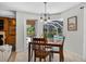 Bright dining area with backyard pool views and natural light, ideal for entertaining guests and enjoying Gathering meals at 6875 Myakka Valley Trl, Sarasota, FL 34241
