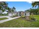 Charming one-story home with a well-manicured lawn and colorful landscaping at 6875 Myakka Valley Trl, Sarasota, FL 34241