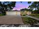 Charming single-story home with a three-car garage, manicured landscaping, and a welcoming front entrance at 6875 Myakka Valley Trl, Sarasota, FL 34241
