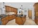 Kitchen with island, wood cabinets and floors at 6875 Myakka Valley Trl, Sarasota, FL 34241