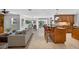 Open-concept living room with neutral colors, ceramic tile floor, and views of the backyard pool area at 6875 Myakka Valley Trl, Sarasota, FL 34241