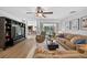 Open-concept living room with hardwood floors and a view of the pool through sliding glass doors at 6875 Myakka Valley Trl, Sarasota, FL 34241