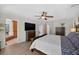 Spacious main bedroom with a tray ceiling, ceiling fan, and an en suite bathroom with a separate tub at 6875 Myakka Valley Trl, Sarasota, FL 34241