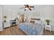 Comfortable bedroom with ceiling fan, wood-look floors, and neutral decor at 6875 Myakka Valley Trl, Sarasota, FL 34241