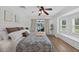Relaxing bedroom with pool view, bay window seating, ceiling fan, and wood-look flooring at 6875 Myakka Valley Trl, Sarasota, FL 34241