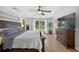 Inviting bedroom with a tray ceiling, wood flooring, and a view of the outdoors, perfect for relaxation at 6875 Myakka Valley Trl, Sarasota, FL 34241